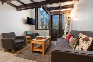 a living room with a couch and chairs and a table at Résidence Grand Roc - Campanules 114 in Chamonix
