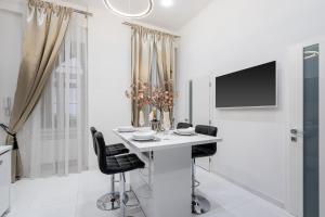 A television and/or entertainment centre at Opera Balkony Luxury Apartment with free parking