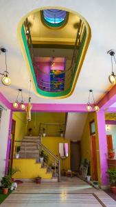 a lobby with stairs and a colorful ceiling at The Old Town Hostel in Pushkar