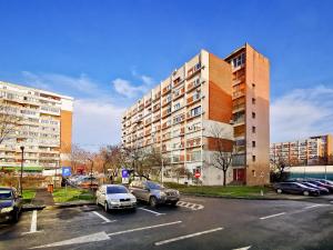 a parking lot with cars parked in front of a building at Danube Residence in Galaţi