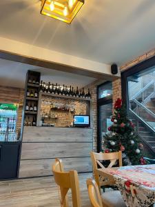 a restaurant with a christmas tree in the dining room at Zarevata Guest House in Velingrad