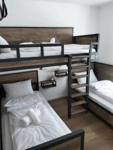 a room with three bunk beds with towels at Matrix in Jahorina