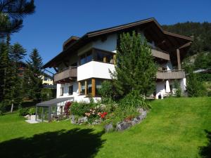 a house on a hill with a green yard at Appartementhaus St. Martin in Seefeld in Tirol