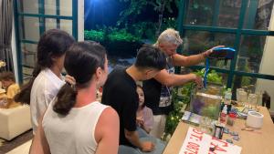 a group of people standing around a table looking at something at Larosa Hotel in Phu Quoc