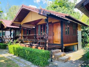 a small wooden house with a porch and stairs to it at I-Lay House Koh Kood in Ko Kood