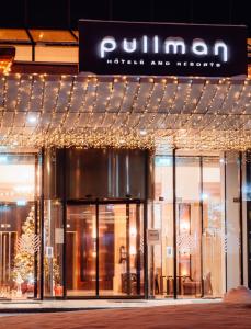 a store front with christmas lights in front of it at Pullman Bucharest World Trade Center in Bucharest