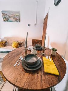 a wooden table with plates and utensils on it at 2 bedroom house perfect for contractors in Birmingham