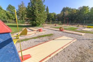 a playground with wooden ramps in a park at Wellness Hotel Katalin in Gyenesdiás