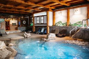 a large swimming pool in a large room at Etno Village Cardaci in Vitez