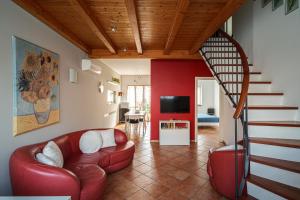 米蘭的住宿－Accomodo MIT39 Trivano San Siro，一间带红色沙发的客厅和楼梯