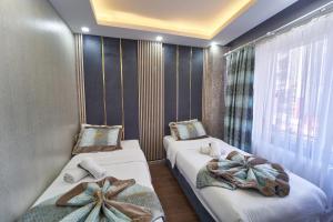 a bedroom with two beds with bows on them at Istanbul Sirkeci Hotel in Istanbul