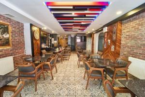 a restaurant with tables and chairs and a brick wall at Istanbul Sirkeci Hotel in Istanbul
