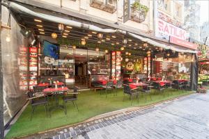 a restaurant with tables and chairs in a street at Istanbul Sirkeci Hotel in Istanbul