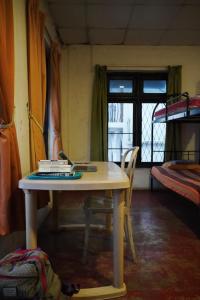 a table with a laptop on it in a room at City View Hostel in Kandy