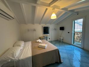 a bedroom with a bed with two towels on it at CASA MEDUSA in La Spezia