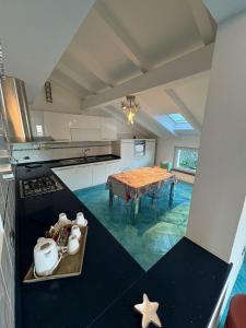 a large kitchen with a table in the middle at CASA MEDUSA in La Spezia