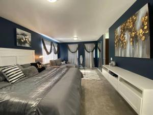 um quarto com uma cama grande e paredes azuis em SAFARI VILLA: Luxurious private villa w grand deck em Snohomish