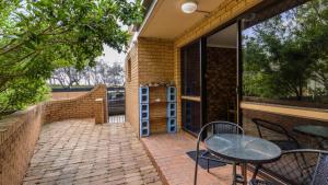 a patio with a table and chairs and a window at Wake Up To Sounds Of The Ocean in Woorim