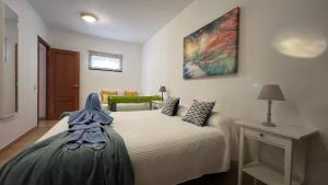 Łóżko lub łóżka w pokoju w obiekcie Vivienda Vacacional Orquidea