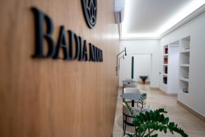 a conference room with a table and chairs and a clock at BADIA NUOVA Apart Hotel in Trapani