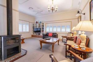 a living room with a fireplace and a couch at The Guesthouse Maleny in Maleny