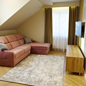 a living room with a couch and a table at Apartamenty u ROXI in Jelenia Góra
