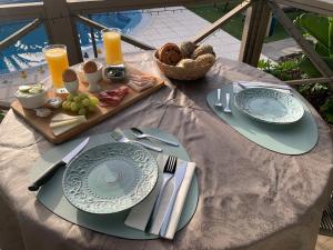 una mesa con platos y utensilios y una bandeja de comida en B&B Casa en La Montaña en Montana la Data