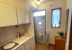 a kitchen with a sink and a shower in it at Yokohama Ivy 101 - 横浜 アイビー清水ヶ丘101 - in Yokohama