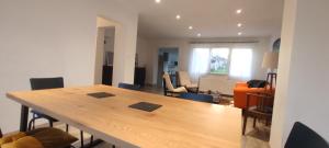 a living room with a wooden table in a room at Freddy's house in Wimille