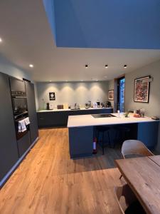 a large kitchen with a table and a counter at Modern house by the Fjord in Sandane, Nordfjord. in Sandane