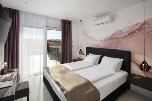 a bedroom with a large bed and a window at Villa Monte Kope in Banjole +32 photos
