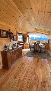 a kitchen and dining room with a table in a cabin at Nasza Chata in Jaworzynka