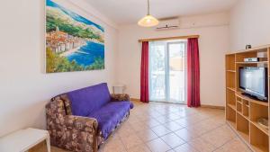 a living room with a couch and a tv at Große Terrasse mit Meerblick, Strand 200 Meter in Baška