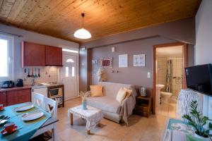 a living room with a couch and a kitchen at Belleza Villa in Lixouri