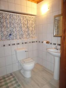 a bathroom with a toilet and a sink at Serendipity self catering one bedroom apartment in Despatch +7 photos