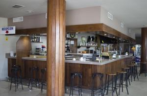 a bar in a restaurant with bar stools at Hotel Costa Blanca in Granja de Rocamora