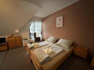 a large bedroom with two beds and a window at Penzion Verde Rosa in Harrachov