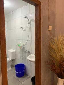 a bathroom with a shower and a toilet and a sink at Great Panorama Lodge and Camping in Lembang