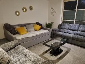 a living room with a couch and a table at Stefo Maisonette Sleeps 6 in Leicester