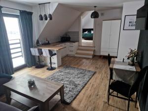 a living room with a table and a kitchen at Widokowa Polana in Szaflary