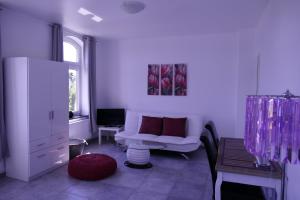 a living room with a white couch and a window at Villa Luise in Hameln