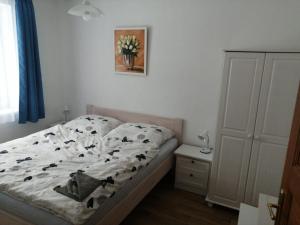 a bedroom with a bed with cow print sheets at Slavonice - Maříž in Maříž