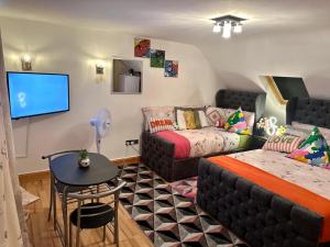 a living room with a bed and a couch at Elegant Square in Hither Green