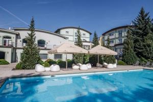 basen przed budynkiem z parasolami w obiekcie Parkhotel Plzen Congress Center w Pilznie