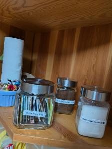 three glass jars sitting on a shelf with soap at Kranio in Karlovy Vary