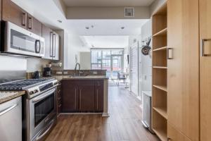 a kitchen with a sink and a stove at East Village 1br w rooftop nr park bars SAN-40 in San Diego