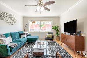 a living room with a green couch and a flat screen tv at Concord 3br w backyard patio nr Mt Diablo SFO-1579 in Concord