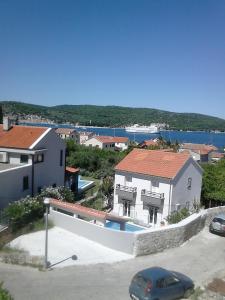 a house with a swimming pool in a parking lot at Apartments Bilić in Vis