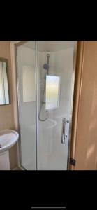 a shower stall in a bathroom with a sink at 9 shearwater Tattershall Lakes Country Park in Tattershall