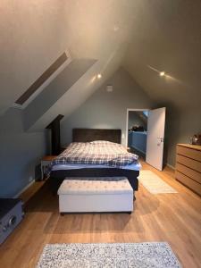 a attic bedroom with two beds and a mattress at Modern house by the Fjord in Sandane, Nordfjord. in Sandane